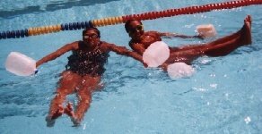 Picture of holding milk jugs and lifting feet above water